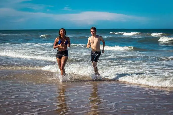 a couple splashing in the waves in Ormond Beach
