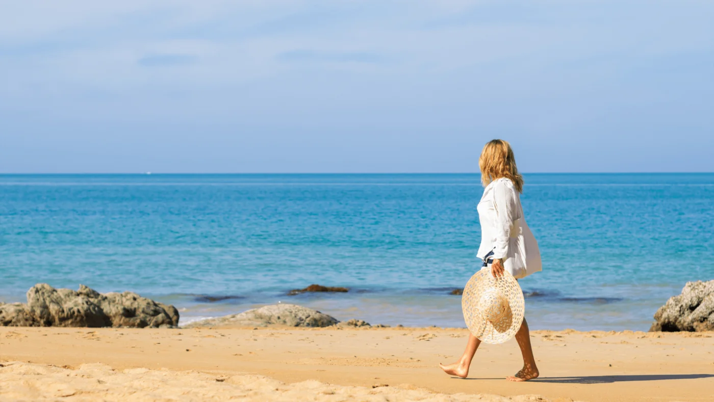 Lady walking along beach