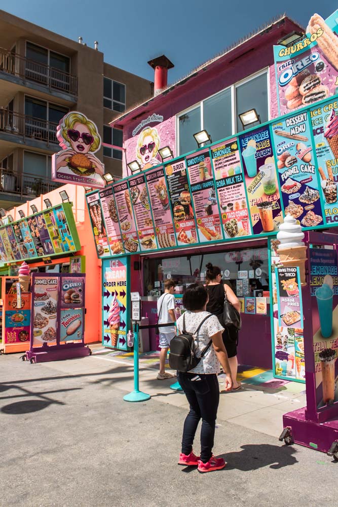 Jeanette looking at food stand in Venice Beach